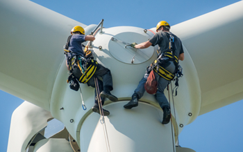 Access workers at the top of a wind turbine